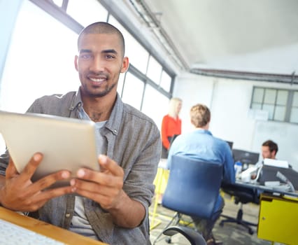 I love what I do. Portrait of a designer using a digital tablet while working in an office