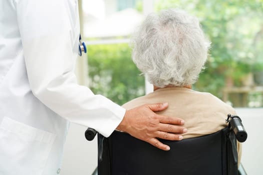 Doctor help Asian elderly woman disability patient sitting on wheelchair in hospital, medical concept.