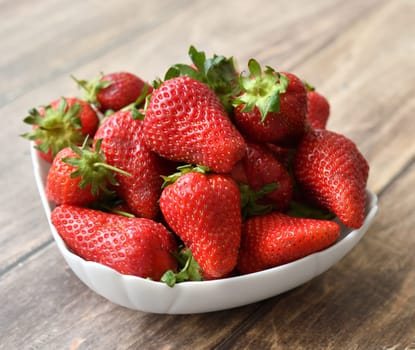 Ripe strawberries on wooden background