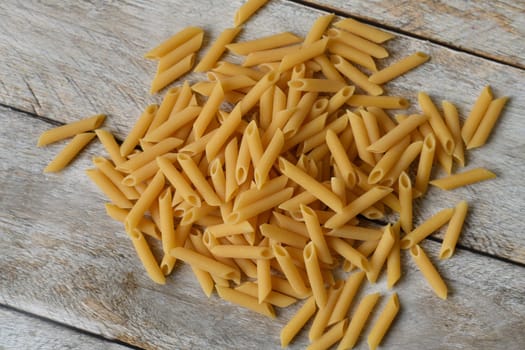 Uncooked Italian pasta. The Heap of raw pasta.