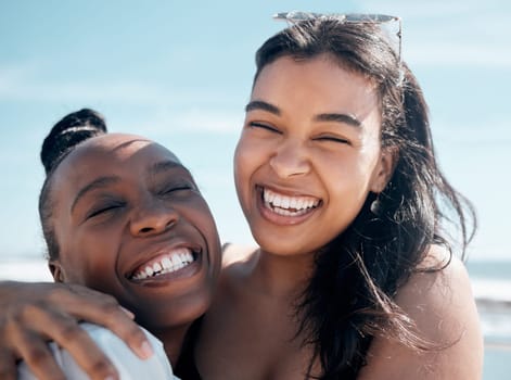 Woman, friends and hug with smile for beach day, summer vacation or travel together outdoors. Portrait of happy women laughing in joy for friendship, travel or fun holiday bonding by the ocean coast.