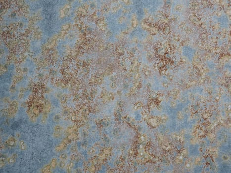 Corroded metal background. Texture of oxidized metal with brass and aqua patina. Rusty metal surface with streaks of rust. Rusty corrosion. Brown, grey, blue and orange rust and dirt on enamel.