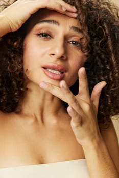 Woman beauty face close-up skin health nails and hair, hair dryer style curly afro hair, body and beauty care concept. High quality photo