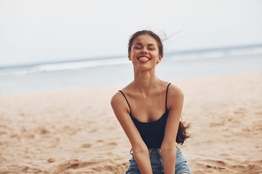 woman tan holiday happy water sea beach travel sitting tropical smile person ocean adult girl sand vacation summer hair long nature freedom