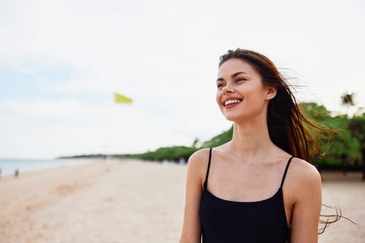 sand woman beach water summer nature travel dress copy-space adult holiday young sea ocean person shore beautiful carefree relax vacation smile