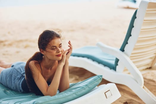 resting woman lying enjoy summer tan sand sunbed resort beach sea beach travel sunglasses water tropical smiling chair sitting girl lifestyle ocean