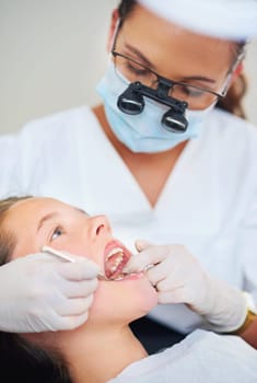 Open wide...a female dentist and child in a dentist office