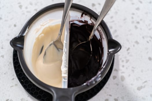 Melting chocolate chips in a candy melting pot to make Halloween chocolate-covered pretzel rods.