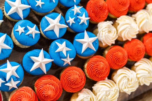 Arranging mini vanilla cupcakes in the shape of the American flag.