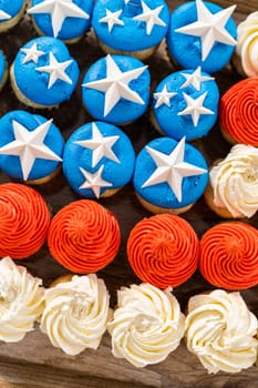 Arranging mini vanilla cupcakes in the shape of the American flag.