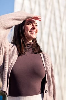 smiling young woman enjoying the city on sunny day, concept of happiness and urban lifestyle