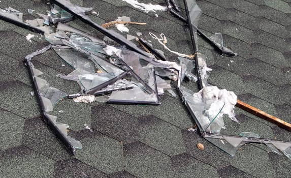 Broken roof after a storm. A large building with a damaged roof after a strong hurricane with broken glass and window frames