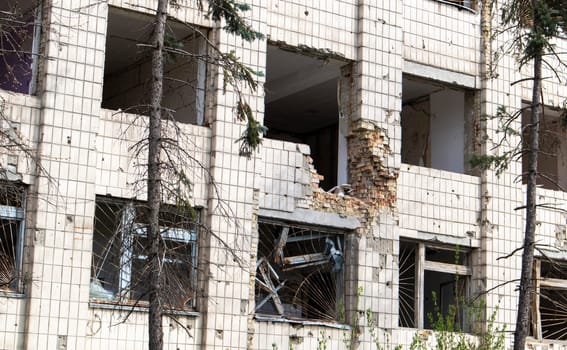 Burnt apartments in a multi-storey residential building, the consequences of the war in Ukraine. Buildings damaged by shells. A bombed-out apartment building after an airstrike