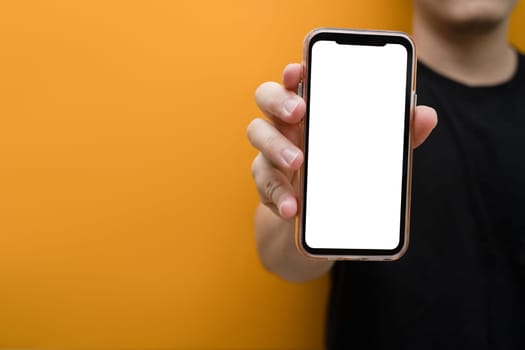 Closeup view of man hand holding mockup smartphone. Blank screen for your own webpage or advertise text.