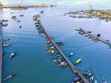Aerial top down on traditional colourful asian fisherman boats moored in Gresik, Indonesia. Drone Photography. Aerial Photography.