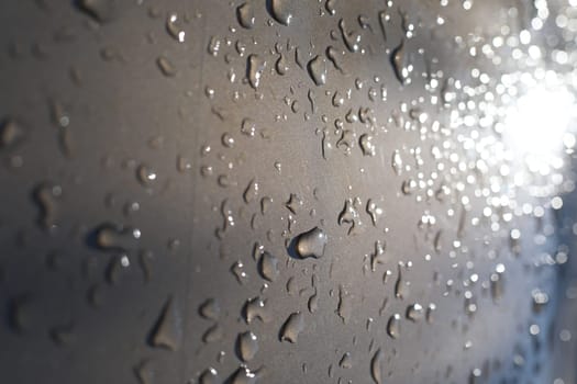 Drops of water on a color background. Selective focus. Gray. High quality photo