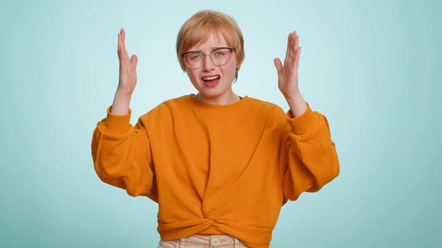 Sad unhappy young woman feeling hopelessness loneliness, nervous breakdown, loses becoming surprised by lottery results, bad fortune, loss, unlucky news. Blonde girl isolated on studio blue background