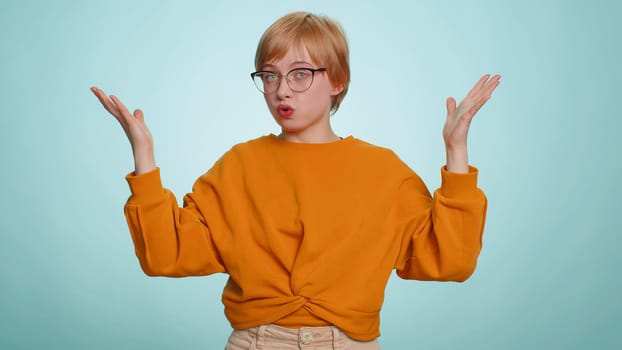 Excited amazed woman touching head and showing explosion, looking worried and shocked, celebrating success idea. Looking surprised of win wow blonde girl isolated alone on blue studio background
