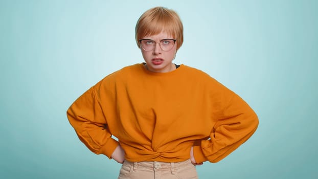 Offended sad nervous woman having misunderstanding, frustrated after quarrel, fail, lose, ignores and does not want to communicate, talk. Girl isolated on blue studio background. People lifestyle