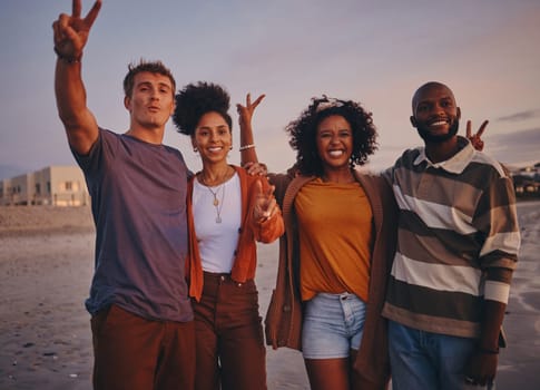 Diversity, friends and on beach at sunset show peace, sign or relax together on holiday and vacation. Happy group, smile or on seaside getaway, trip or weekend break have fun, good time or travelling.
