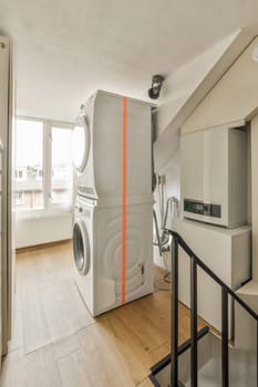 a laundry room with a washer, dryer and washing machine on the floor in front of the door