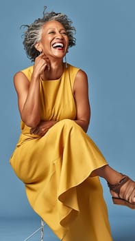 Adult African American woman smiling in a photo studio in a yellow dress on a blue background. Generative AI. High quality illustration