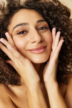 Woman beauty face close-up skin health nails and hair, hair dryer style curly afro hair, body and beauty care concept. High quality photo