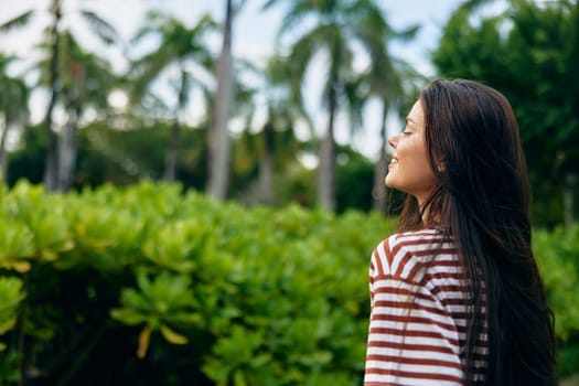 woman hipster smile freedom nature outdoor natural walk t-shirt day long hair beautiful black active walking park smiling relax portrait lifestyle summer