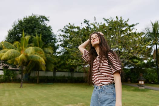 girl woman t-shirt nature bali grass freedom meadow young relax carefree run meditation park walk lifestyle summer smiling walking beautiful striped