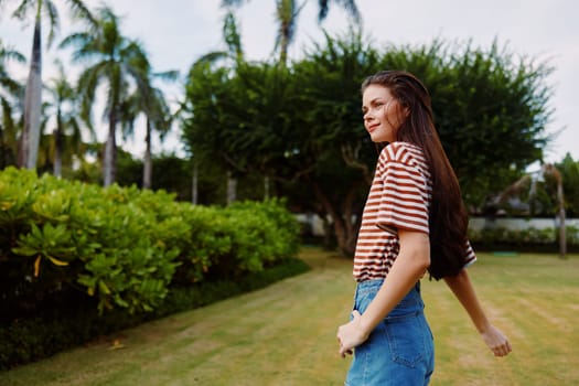 lifestyle woman t-shirt summer person long wellness freedom smiling hair black enjoy park beautiful walking active walk hat nature grass natural striped