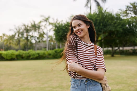 woman t-shirt freedom lifestyle hat natural park relax summer beautiful carefree wellness exercise smiling black active nature fun enjoy walk joy