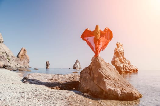 Woman travel sea. Happy tourist taking picture outdoors for memories. Woman traveler looks at the edge of the cliff on the sea bay of mountains, sharing travel adventure journey.