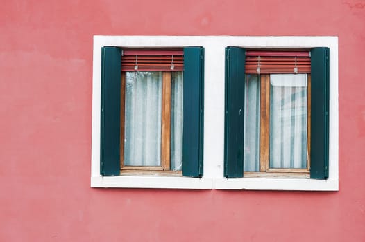 Window of one of the characteristic colored houses of Burano (Venice)