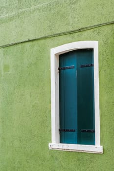 A window of one of the characteristic colored houses of Burano (Venice)