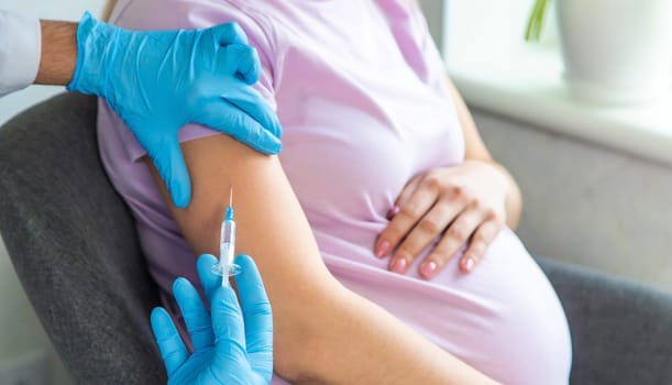 A pregnant woman makes a vaccination. Selective focus. doctor.