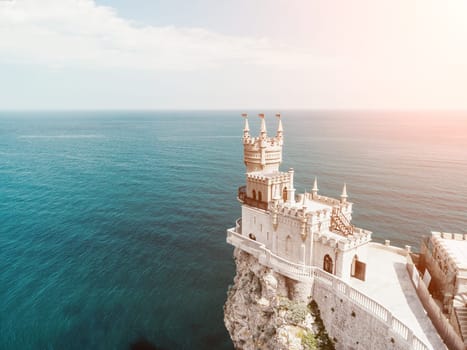 Aerial view of Swallow's Nest castle on the rock in Black Sea. It is a symbol and landmark of Crimea. Beautiful scenic panorama of the Crimea coast. Amazing Swallow's Nest at the precipice.