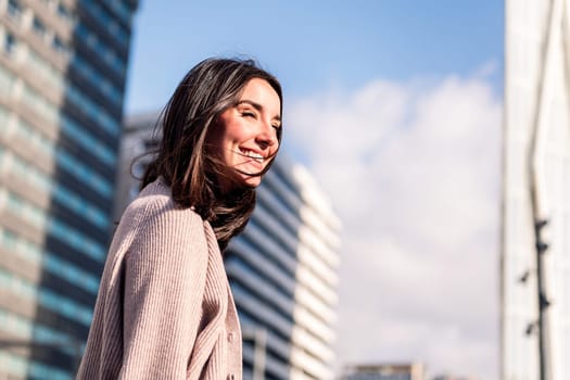 cheerful young woman smiling taking a walk enjoying the city streets, concept of happiness and urban lifestyle, copy space for text