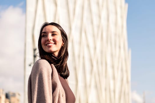 smiling young woman taking a walk enjoying the city streets, concept of happiness and urban lifestyle, copy space for text
