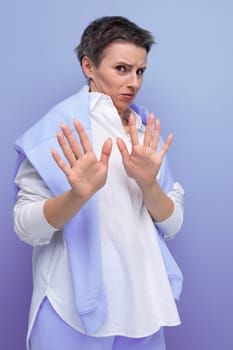 shocked brunette with hair sticking out young woman in casual look.