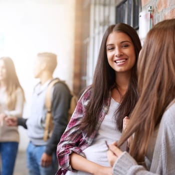 Girl friends, university hallway and female talking with happiness and discussion together. Teenager, college girls and school communication of young and gen z students on campus for education.