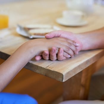 I promise to take care of you. a nurse holding a senior womans hands in comfort