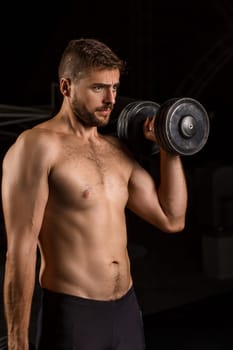 Muscular bodybuilder handsome man doing exercises in outdoor gym naked torso. Athlete Outdoors.