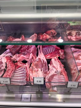 Raw lamb meat on the ribs lies in the refrigerator in the supermarket. High quality photo
