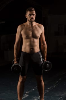 Muscular bodybuilder handsome man doing exercises in outdoor gym naked torso. Athlete Outdoors.