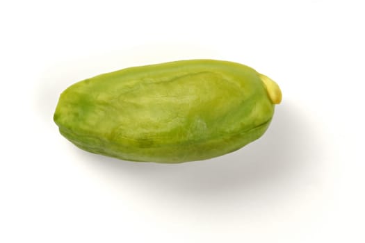 Single green pistachio nut peeled, isolated on white background.
