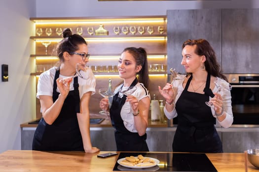 Female chef in uniform holding recipe notebook while smiling at camera