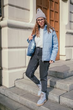 Portrait of a stylish woman in blue jacket. Spring outdoor portrait.