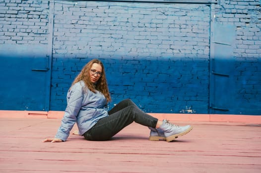 Portrait of a stylish woman in blue jacket. Spring outdoor portrait.