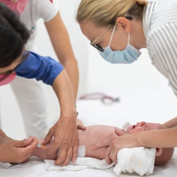 Baby beeing vaccinated by pediatrician in presence of his mother. Preventive vaccination against Diphtheria, whooping cough, tetanus, hepatitis, haemophilus influenzae, pneumococcus, poliomyelitis.