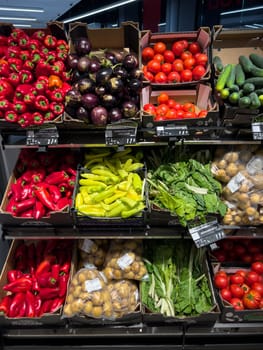 Fresh vegetables lie in boxes on the shelves in the store. High quality photo